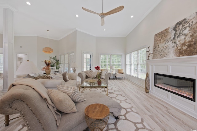 4100 Hagwood Cir, Conway, SC 29526 - living room featuring plenty of natural light, a towering ceiling, light wood-style flooring, ornamental molding, and ceiling fan