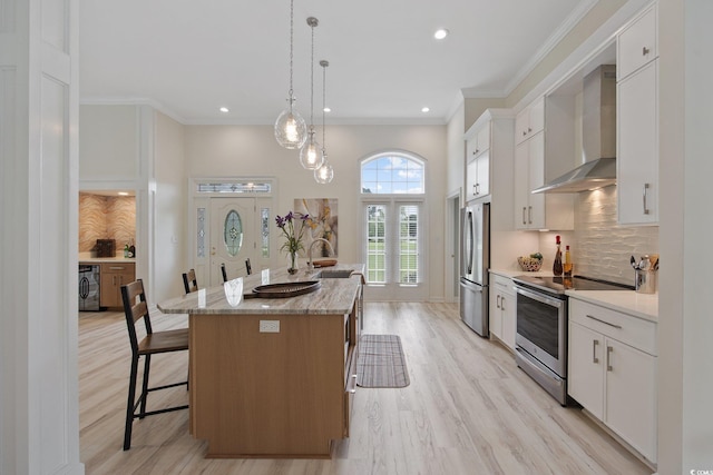 4100 Hagwood Cir, Conway, SC 29526 - kitchen featuring stainless steel appliances, wall chimney exhaust hood, a center island with sink, a kitchen breakfast bar, and a sink