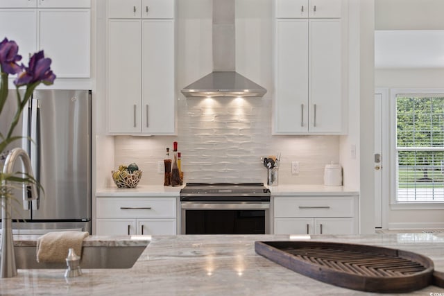4100 Hagwood Cir, Conway, SC 29526 - kitchen featuring wall chimney range hood, appliances with stainless steel finishes, white cabinetry, and light stone countertops
