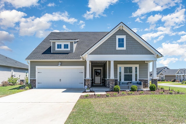 craftsman inspired home with stone siding, a porch, an attached garage, and a front lawn