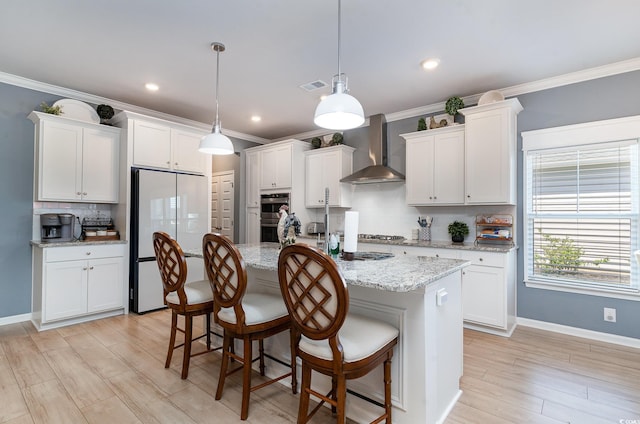 kitchen with tasteful backsplash, white refrigerator, stainless steel double oven, visible vents, and wall chimney exhaust hood