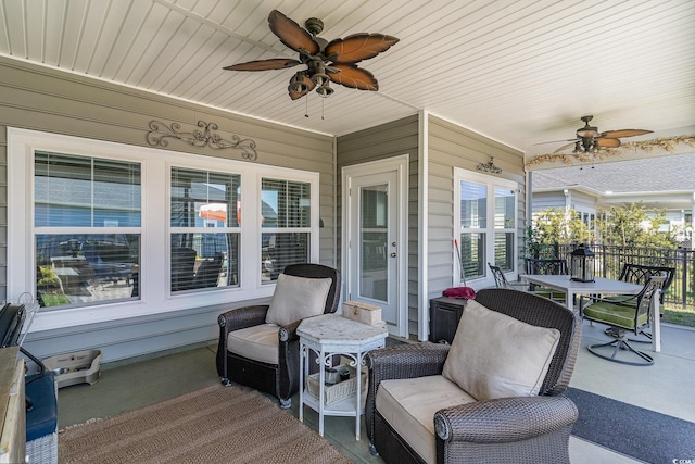 view of patio with an outdoor hangout area, fence, and a ceiling fan