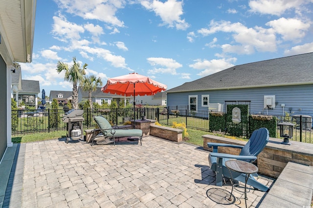 view of patio / terrace featuring fence and a grill