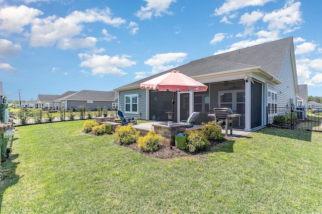 back of property featuring a lawn, a patio, a sunroom, and a fenced backyard