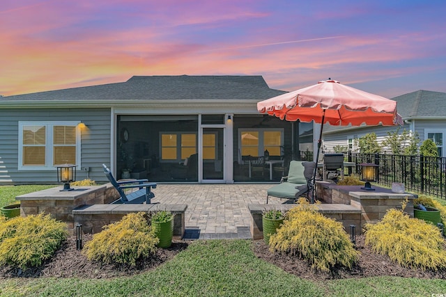rear view of house with a patio and fence