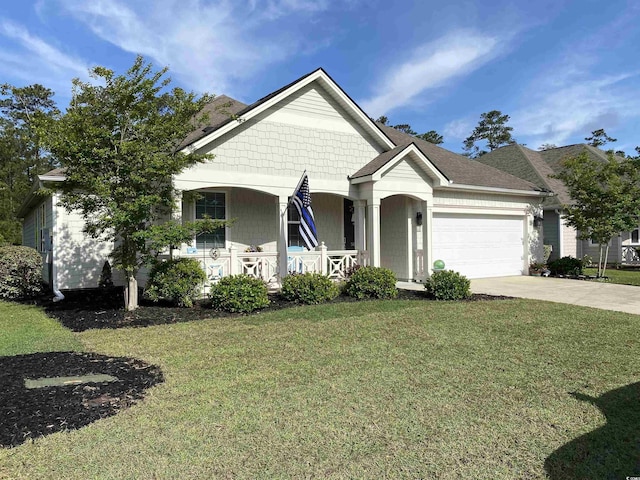 view of front facade featuring a garage, driveway, a front lawn, and covered porch