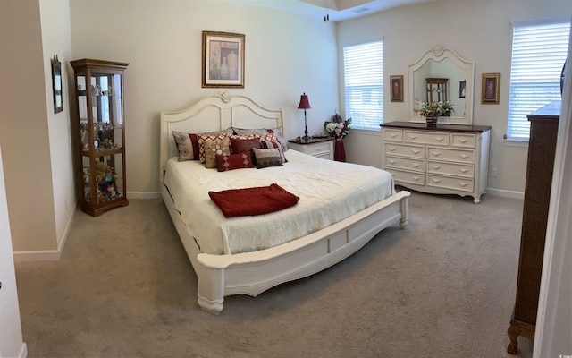 carpeted bedroom featuring baseboards