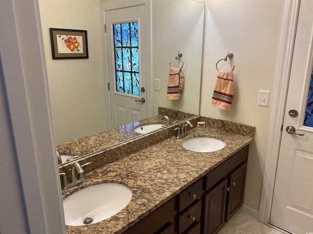 full bathroom featuring double vanity and a sink