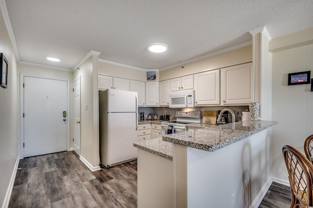 720 N Waccamaw Dr Unit 207, Garden City Beach, SC 29576 - kitchen with light stone countertops, white appliances, dark wood-style floors, and white cabinetry