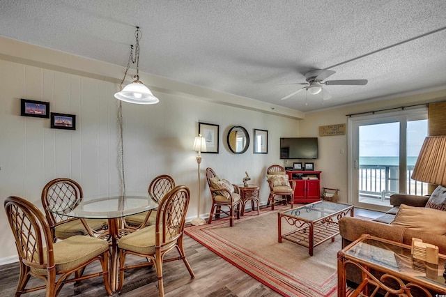 720 N Waccamaw Dr Unit 207, Garden City Beach, SC 29576 - dining area featuring ceiling fan, a textured ceiling, and wood finished floors