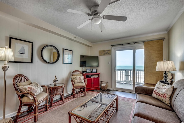 720 N Waccamaw Dr Unit 207, Garden City Beach, SC 29576 - living area featuring a textured ceiling, ornamental molding, a ceiling fan, wood finished floors, and baseboards
