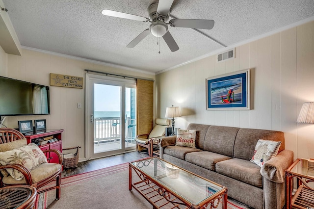 720 N Waccamaw Dr Unit 207, Garden City Beach, SC 29576 - living area with ornamental molding, a textured ceiling, visible vents, ceiling fan, and wood finished floors