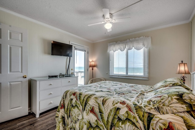720 N Waccamaw Dr Unit 207, Garden City Beach, SC 29576 - bedroom featuring crown molding, a textured ceiling, a ceiling fan, and dark wood finished floors