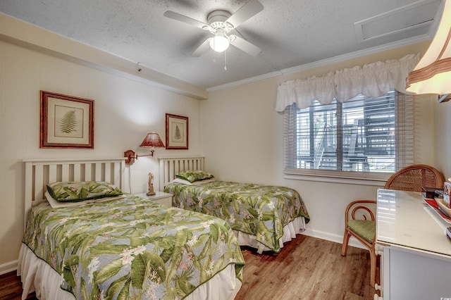 720 N Waccamaw Dr Unit 207, Garden City Beach, SC 29576 - bedroom with baseboards, a textured ceiling, attic access, a ceiling fan, and wood finished floors