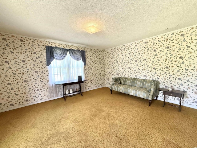 sitting room with a textured ceiling, wallpapered walls, baseboards, and carpet floors