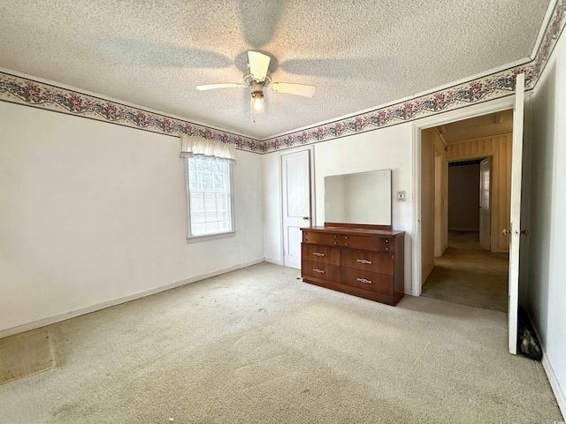 unfurnished bedroom with light carpet, a textured ceiling, a ceiling fan, and a closet