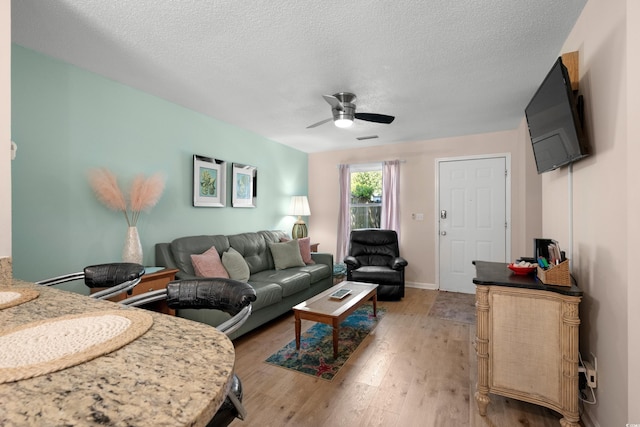 707 S 26th Ave S Unit L, North Myrtle Beach, SC 29582 - living area with ceiling fan, light wood-type flooring, a textured ceiling, and baseboards