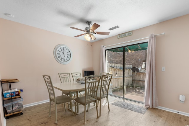 707 S 26th Ave S Unit L, North Myrtle Beach, SC 29582 - dining space with a ceiling fan, wood finished floors, baseboards, and a textured ceiling