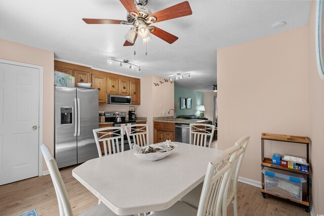 707 S 26th Ave S Unit L, North Myrtle Beach, SC 29582 - dining area with ceiling fan, light wood-style floors, and baseboards