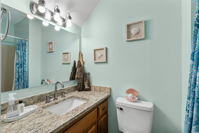 707 S 26th Ave S Unit L, North Myrtle Beach, SC 29582 - bathroom with vanity, toilet, a textured ceiling, and a shower with shower curtain