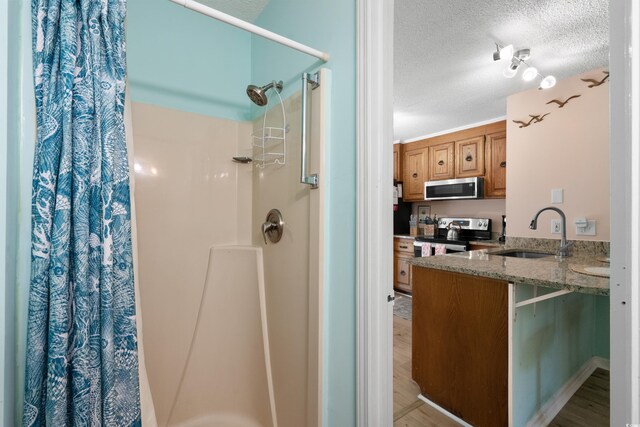707 S 26th Ave S Unit L, North Myrtle Beach, SC 29582 - bathroom featuring a textured ceiling, a shower with curtain, wood finished floors, and vanity