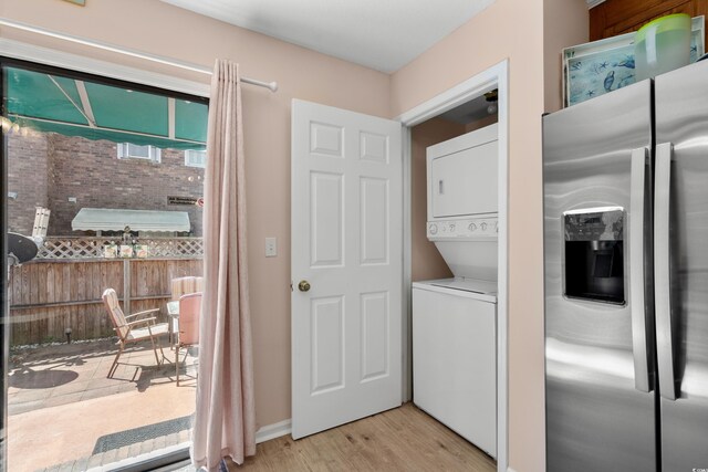 707 S 26th Ave S Unit L, North Myrtle Beach, SC 29582 - laundry room with stacked washing machine and dryer and light wood finished floors