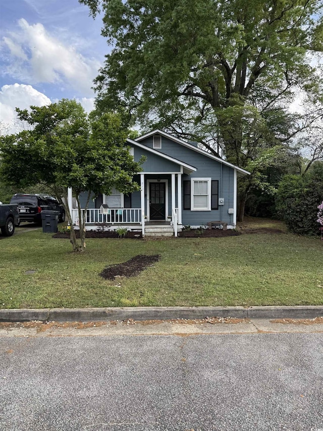 bungalow-style house featuring a porch and a front lawn