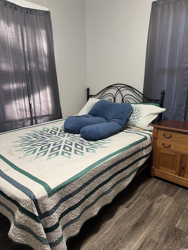 bedroom featuring dark wood-type flooring