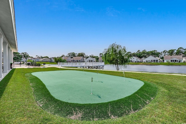 view of property's community with a residential view, a water view, and a lawn