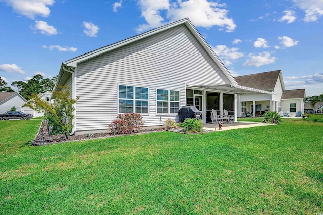 back of house featuring a yard and a patio