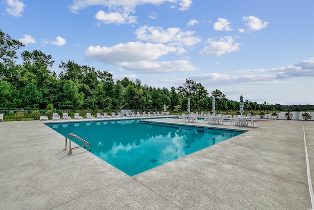 pool with fence and a patio area