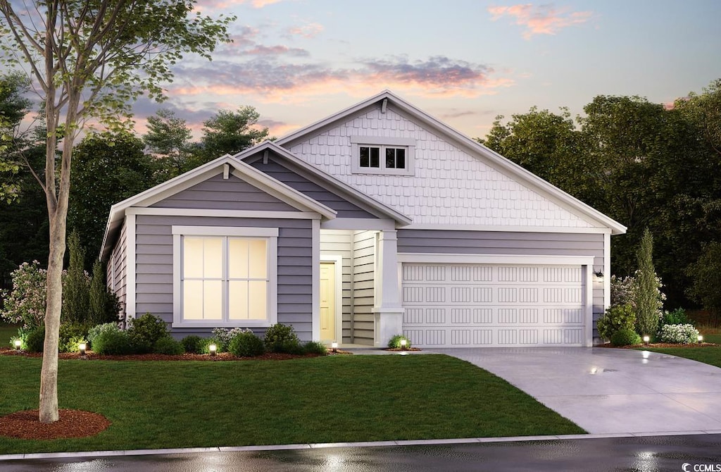 view of front of home featuring an attached garage, driveway, and a front yard