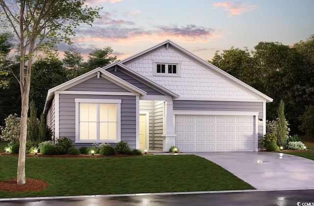 view of front of home featuring an attached garage, driveway, and a front yard