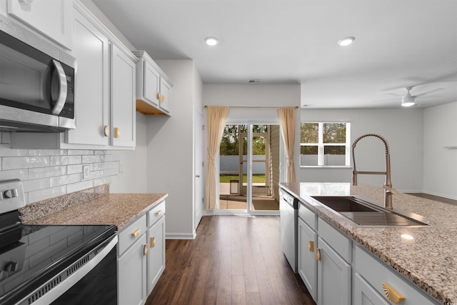 591 Meadowgrass Ct, Myrtle Beach, SC 29588 - kitchen with white cabinets, dark wood finished floors, stainless steel appliances, a sink, and tasteful backsplash