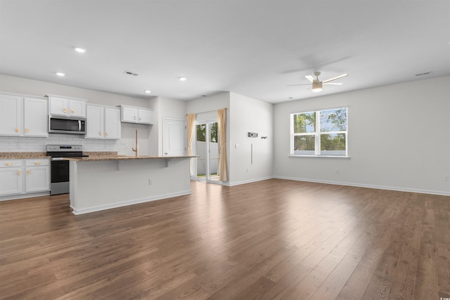 591 Meadowgrass Ct, Myrtle Beach, SC 29588 - kitchen featuring stainless steel appliances, dark wood-style floors, open floor plan, and a wealth of natural light