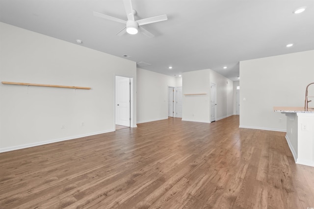 591 Meadowgrass Ct, Myrtle Beach, SC 29588 - unfurnished living room with light wood-style flooring, baseboards, recessed lighting, and a ceiling fan