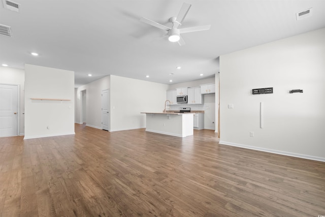 591 Meadowgrass Ct, Myrtle Beach, SC 29588 - unfurnished living room with wood finished floors, visible vents, and a ceiling fan