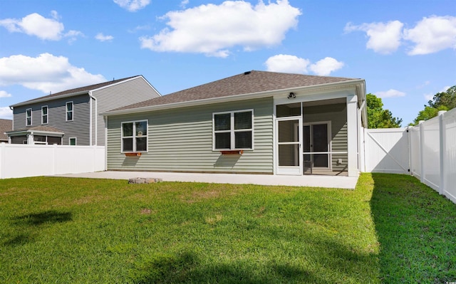 591 Meadowgrass Ct, Myrtle Beach, SC 29588 - rear view of house with a fenced backyard, a sunroom, a patio area, and a lawn