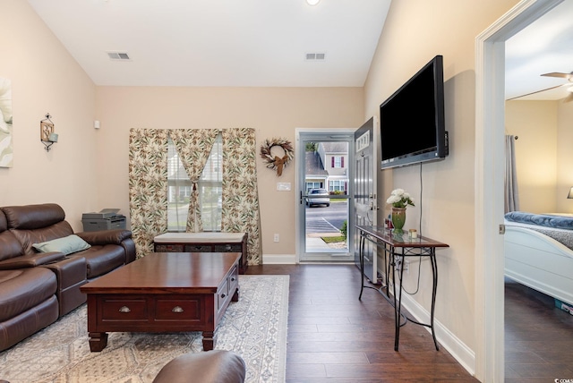 living area featuring baseboards, visible vents, and dark wood-style floors