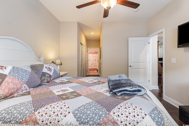 bedroom featuring baseboards, ceiling fan, wood finished floors, and a closet