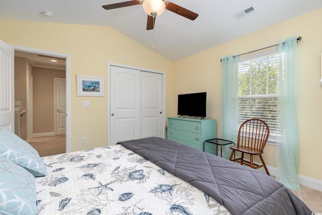 bedroom with visible vents, vaulted ceiling, carpet floors, baseboards, and a closet