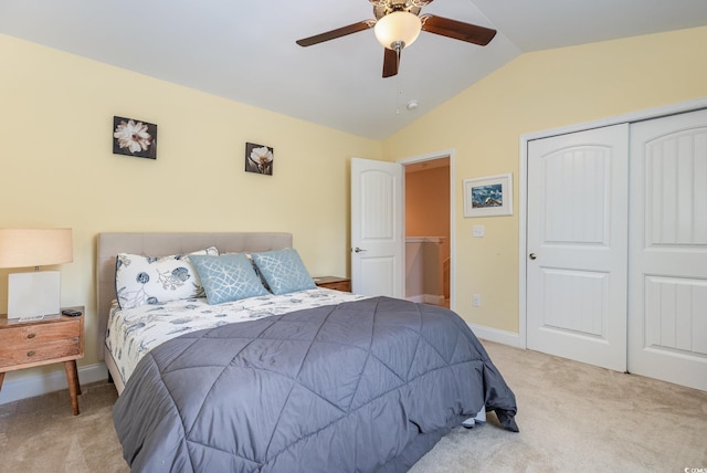 bedroom featuring ceiling fan, carpet floors, baseboards, vaulted ceiling, and a closet