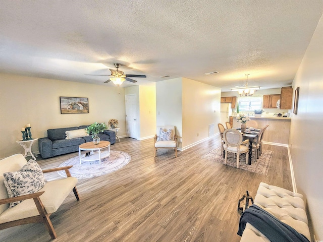 775 Plantation Dr Unit 87, Little River, SC 29566 - living room with a chandelier, a textured ceiling, light wood-style flooring, and a ceiling fan