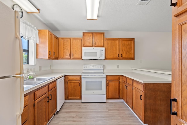 775 Plantation Dr Unit 87, Little River, SC 29566 - kitchen featuring white appliances, light wood-type flooring, a peninsula, and light countertops