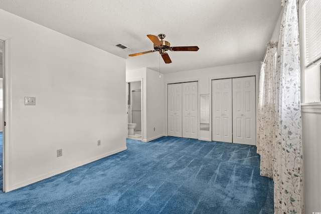 775 Plantation Dr Unit 87, Little River, SC 29566 - unfurnished bedroom featuring carpet floors, two closets, ensuite bathroom, a textured ceiling, and ceiling fan