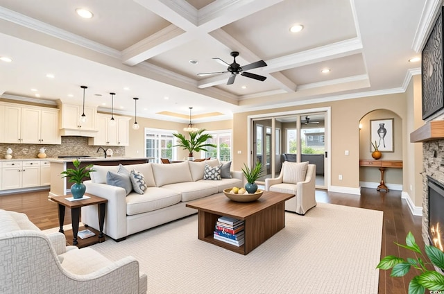7041 Turtle Cove Dr, Myrtle Beach, SC 29579 - living area featuring a ceiling fan, dark wood-style floors, a fireplace, coffered ceiling, and beam ceiling
