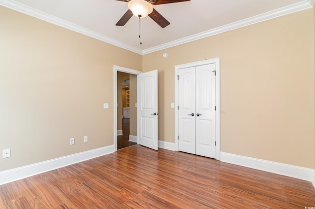 7041 Turtle Cove Dr, Myrtle Beach, SC 29579 - unfurnished bedroom featuring crown molding, baseboards, wood finished floors, a ceiling fan, and a closet