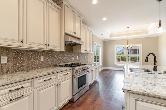 7041 Turtle Cove Dr, Myrtle Beach, SC 29579 - kitchen with stainless steel stove, cream cabinets, a sink, under cabinet range hood, and ornamental molding