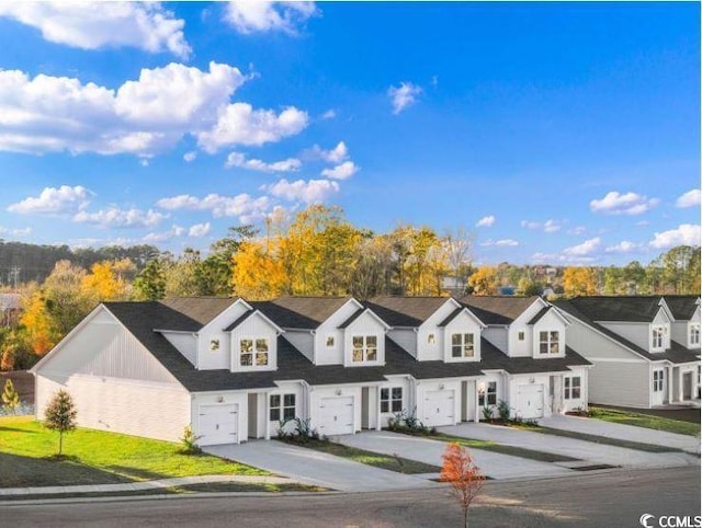 view of front of property with concrete driveway and an attached garage