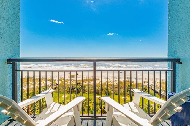 balcony featuring view of water and beach